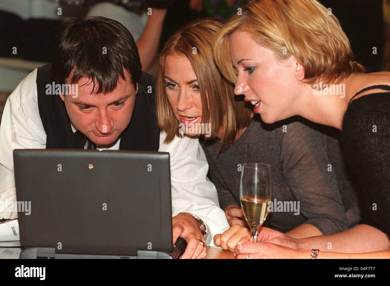 PA NEWS PHOTO 9/9/98 MEG MATHEWS, EHEFRAU VON OASIS-STAR NOEL GALLAGHER, UND MTV-MODERATORIN SARA COX SCHAUEN SICH EINEN COMPUTER BEI DER VORSTELLUNG DES NEUEN SELFRIDGES-GESCHÄFTS IM TRAFFORD PARK IN MANCHESTER AN. Stockfoto