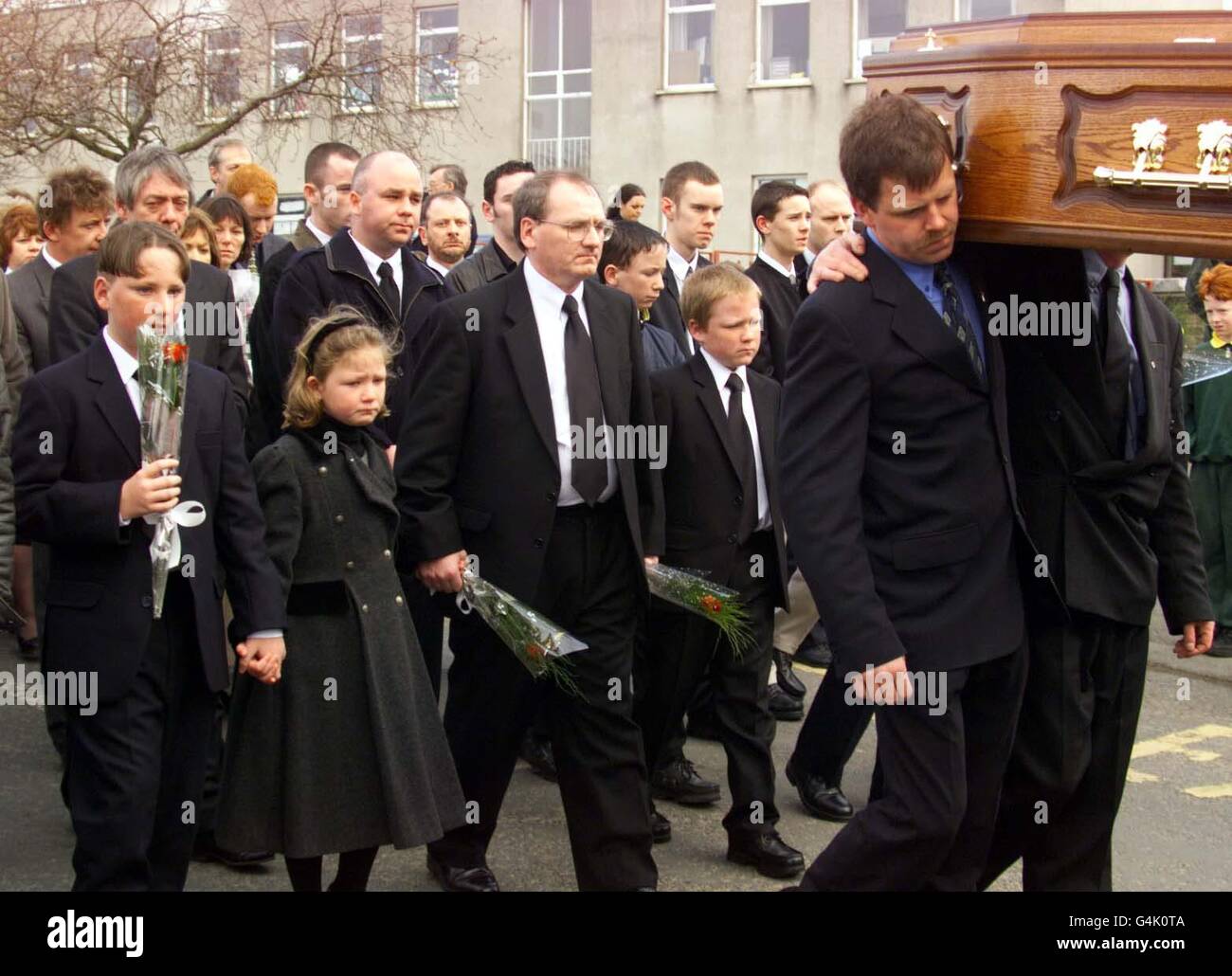Paul Nelson (Mitte) mit seinen Kindern L/R: Gavin (13), Sarah (8) und Christopher (11) während der Beerdigung seiner Frau Rosemary Nelson in Lurgan, Co. Armagh. Frau Nelson starb, als regimekritische Loyalisten, die gegen den Friedensprozess waren, ihr Auto in der Nähe ihres Hauses in die Luft sprengten. * Frau Nelson vertrat viele hochrangige Nationalisten. Stockfoto