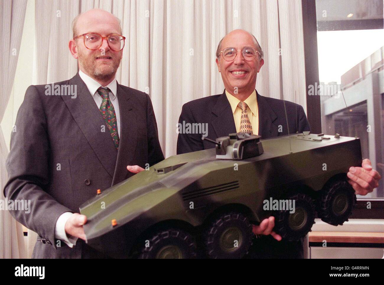 BIBLIOTHEKSFILER vom 15.9.98 des Vorsitzenden der Alvis plc Nick Prest (links) und des Geschäftsführers der GKN Defense David Wright mit einem maßstabsgespielten Modell des Mehrzweckarmierungsfahrzeugs (MRAV). Am Freitag, den 5. November 1999, wurde bekannt gegeben, dass bis zu 500 Arbeitsplätze in der britischen Fertigung durch die Vergabe eines Großauftrages für das neue gepanzerte Fahrzeug für die britische und deutsche Armee gesichert wurden. Das achträdrige Schlachtfeld-Taxi wird von dem deutsch-geführten Artec-Konsortium gebaut, zu dem auch britische Fahrzeughersteller gehören, Alvis, das die Rümpfe in seinem Werk in Telford, Shropshire, bauen wird. PA Foto: Neil Stockfoto