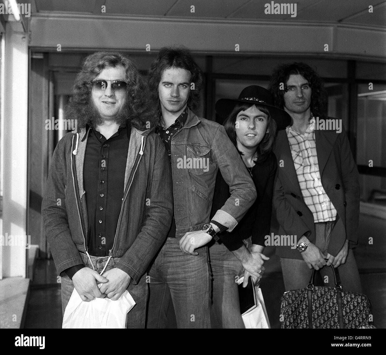 Slade, die Popgruppe (von links) Noddy Holder, Jimmy Lea, Dave Hill und Don Powell am Flughafen Heathrow, London, als sie nach Amerika aufbrechen. Stockfoto