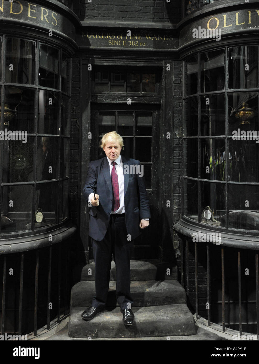 Der Bürgermeister von London Boris Johnson schwingt einen Zauberstab in der Winkelgasse, als er die neue Attraktion "The Making of Harry Potter" in den Warner Brothers Studios in Leavesden, Hertfordshire, besucht. Stockfoto