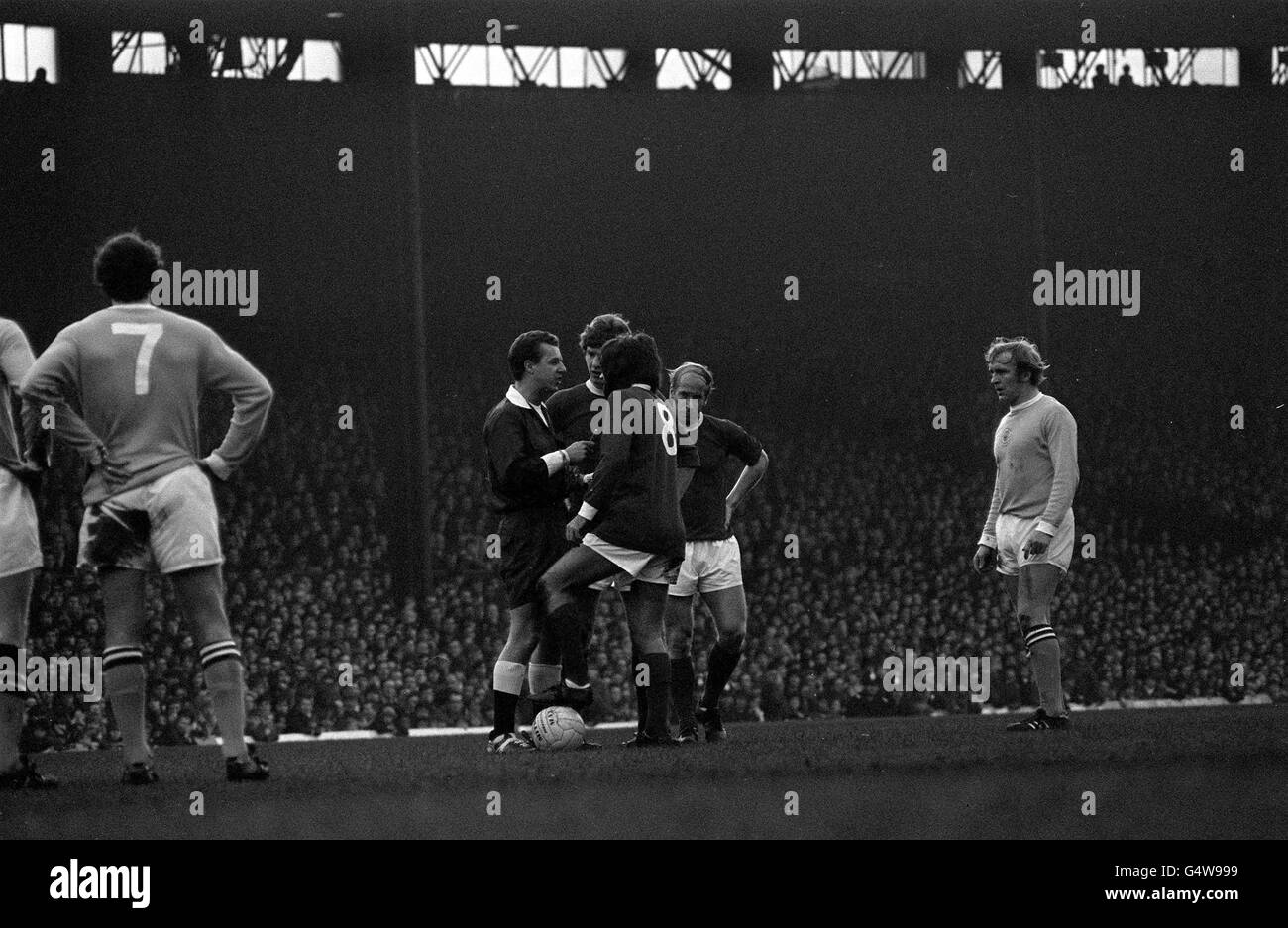 Der Fußballspieler George Best von Manchester United wird von Schiedsrichter John Hamewood im Old Trafford gebucht, nachdem er während des Spiels der Division One mit Glyn Pardoe von Manchester City zusammengestoßen ist. Stockfoto