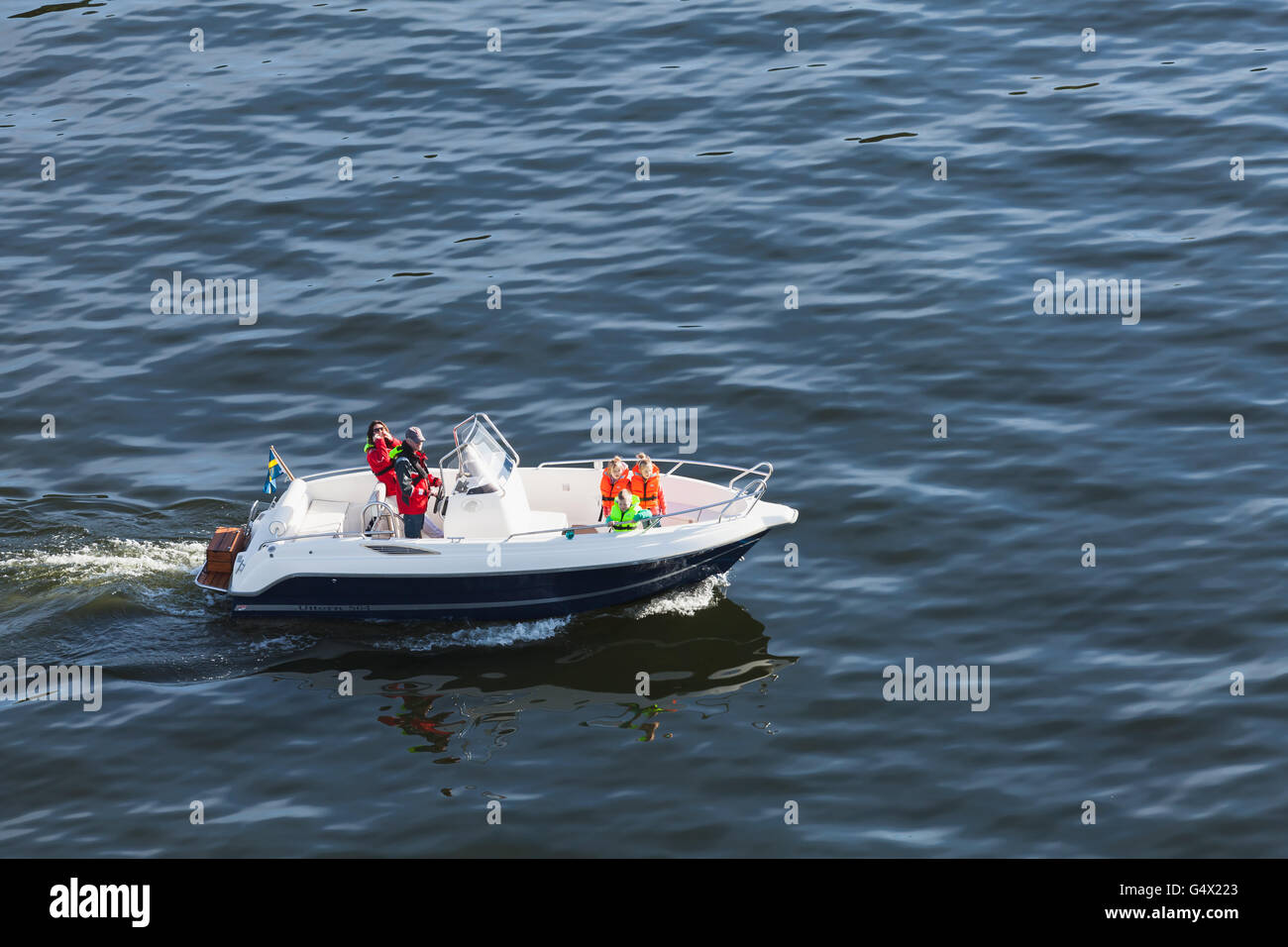 Vaxholm, Schweden - 6. Mai 2016: Gewöhnliche schwedische Familie ist eine Bootsfahrt auf einem kleinen Motorboot Stockfoto