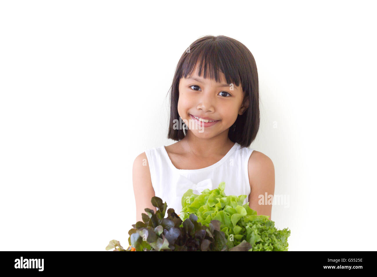 Kinder Mädchen ist Ausdruck von gesunden Lebensmitteln auf weißem Hintergrund Stockfoto