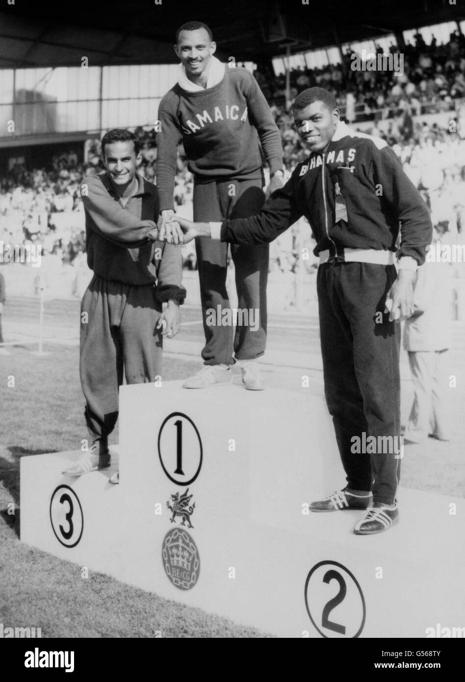 Jamaikas Keith Gardner (c) auf dem Podium, bereit, eine Goldmedaille für den Sieg im 100-Meter-Finale der Männer in einer Rekordzeit von 9.79 zu erhalten. Tom Robinson von den Bahamas (rechts) wurde Zweiter, Mike Agostini aus Kanada (links) wurde Dritter. Stockfoto