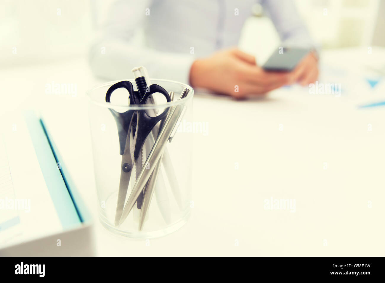 Nahaufnahme des Cups mit Schere und Stiften im Büro Stockfoto