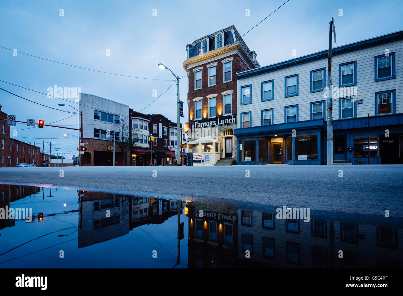 Gebäude entlang der York Street spiegelt sich in einer Pfütze in der Innenstadt von Hannover, Pennsylvania. Stockfoto