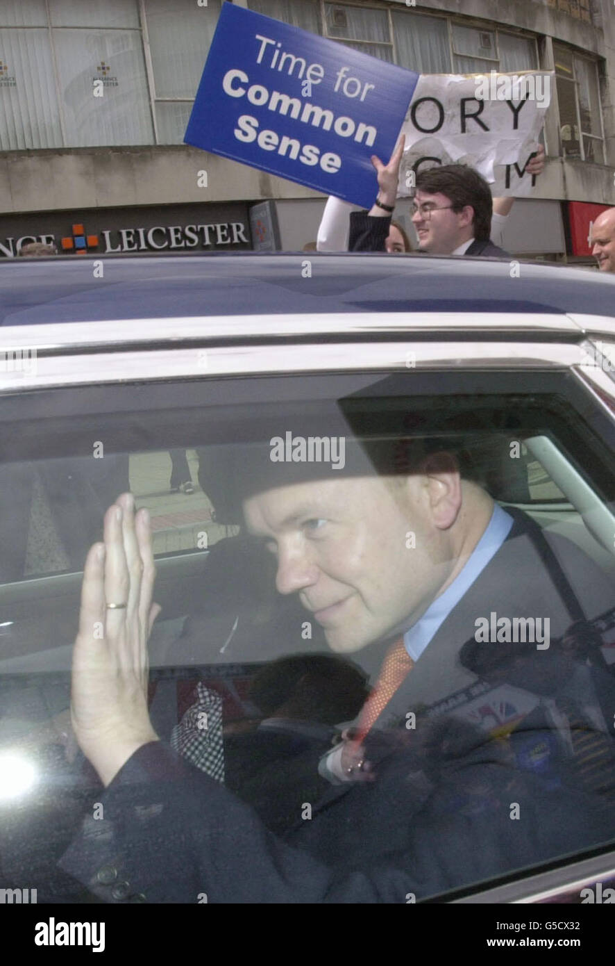Der konservative Führer Wiliam Hague winkt, als er zwei gegensätzliche Plakate passiert, während er in Portsmouth kämpft. Stockfoto