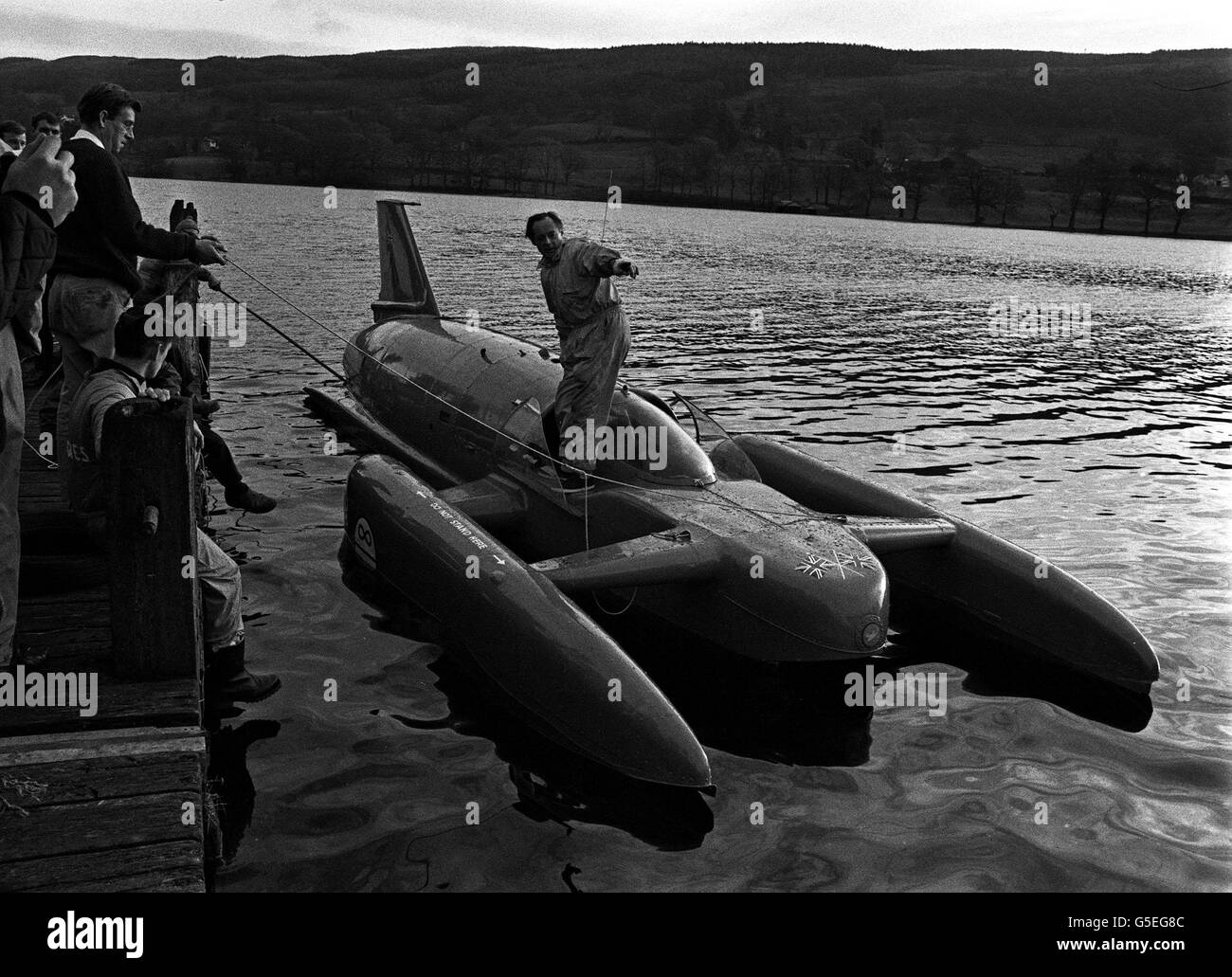 BLUEBIRD 1966: Donald Campbell spricht mit Zuschauern von seinem Boot, Bluebird, auf Coniston Water. Es war der erste ruhige Tag für eine Woche, da er dort für einen Versuch auf seinem eigenen Wasser Geschwindigkeitsrekord, die er in Australien. Er hofft, es auf etwas in der Region von 300 mph zu erhöhen. Stockfoto