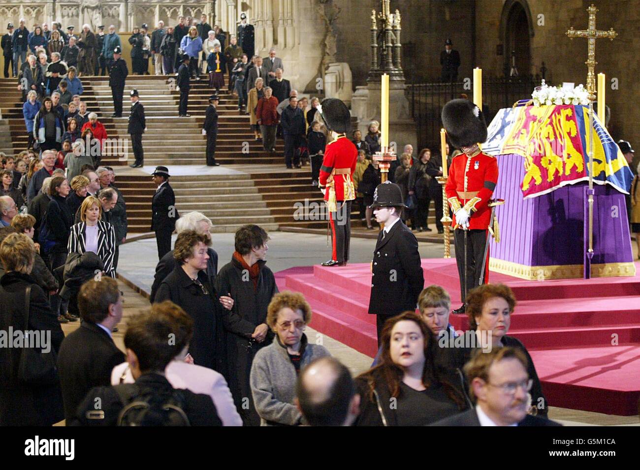 Wachbeamte bewachen den Sarg von Königin Elizabeth, der Königin-Mutter, die im Staat in der Westminster Hall liegt, während Mitglieder der Öffentlichkeit ihre letzte Ehre erweisen, vor ihrer Beerdigung in der Westminster Abbey. Stockfoto