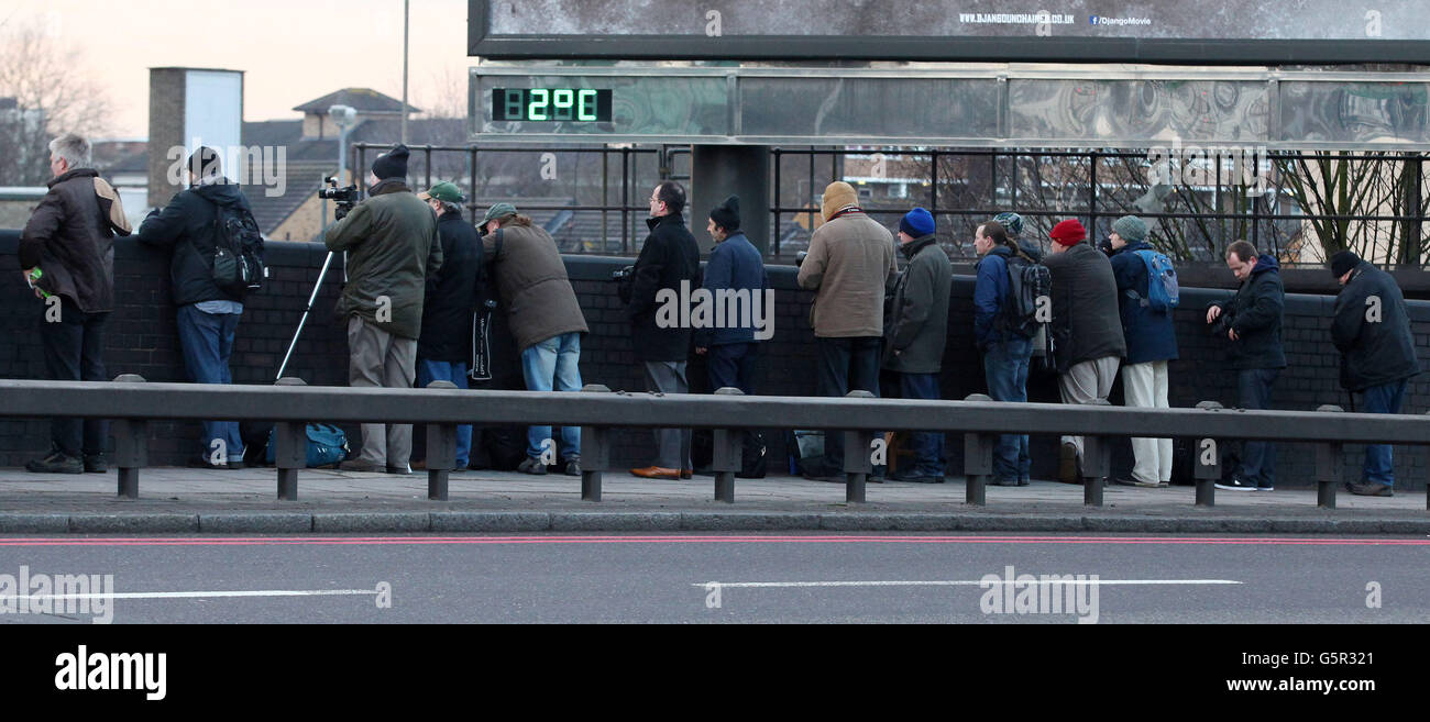 Zugenthusiasten beobachten von einer Straßenbrücke in der Nähe von Earl's Court aus, wie Metropolitan 1, ein restaurierter Dampfzug aus seinen Ställen umkehrt, bevor er im Rahmen der Feierlichkeiten zum 150-jährigen Jubiläum der Londoner U-Bahn von Kensington Olympia nach Moorgate fährt. Stockfoto