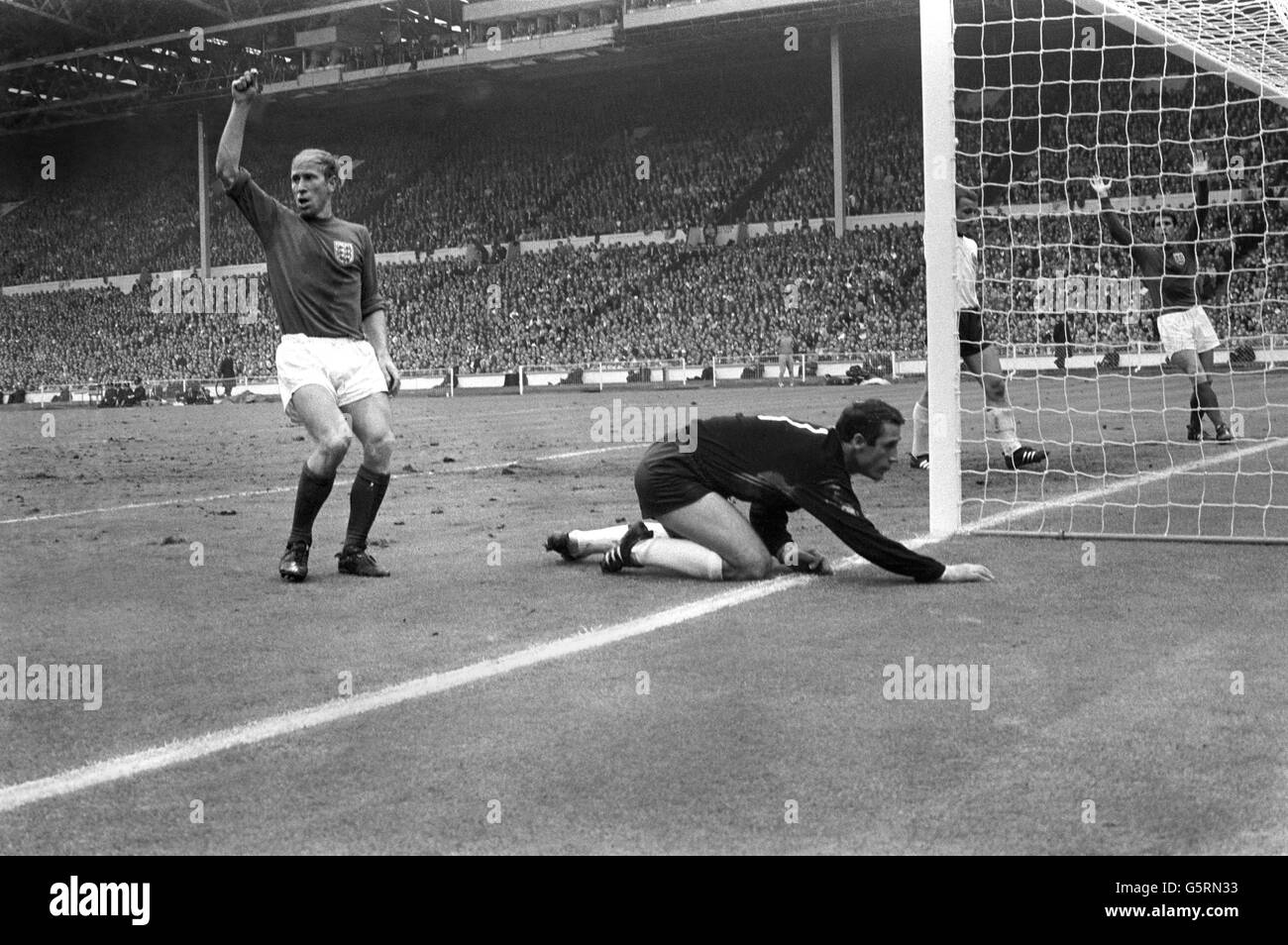 Der englische Bobby Charlton (links) und Geoff Hurst (ganz rechts) appellieren beim Weltcup-Finale 1966 gegen Westdeutschland im Wembley-Stadion an den Schiedsrichter. Stockfoto