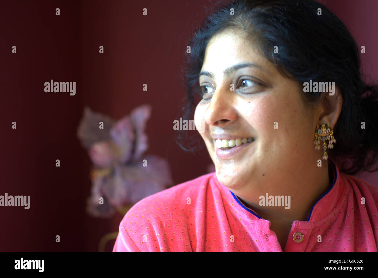 junge indische Dame lächelnd Licht im Gesicht Model-Release Stockfoto