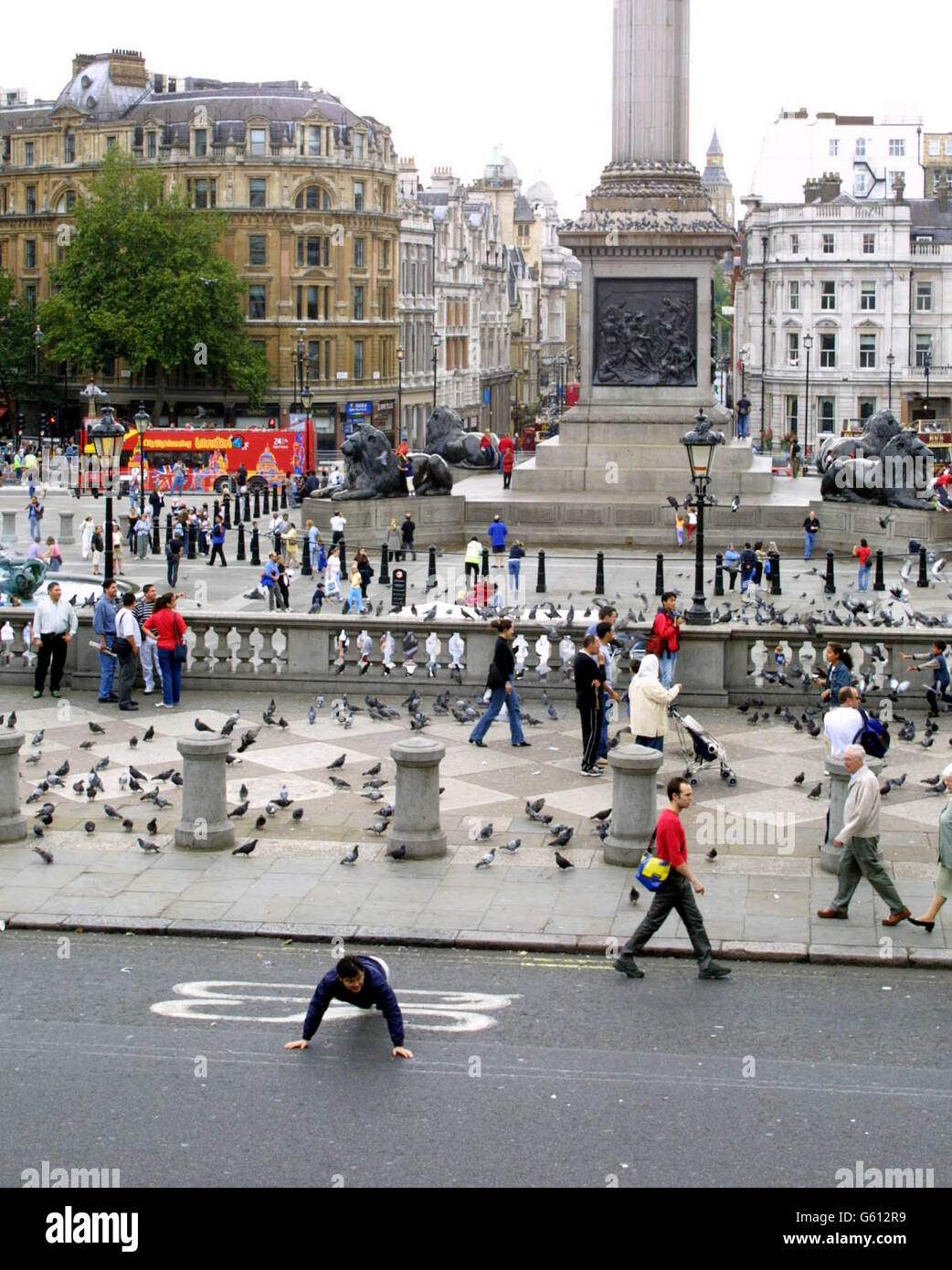 Ein Tourist nutzt die Vorteile, da die Nordseite des Trafalgar Square für den Verkehr gesperrt ist, um das berühmte Londoner Wahrzeichen fußgängerfreundlicher zu machen. Stockfoto