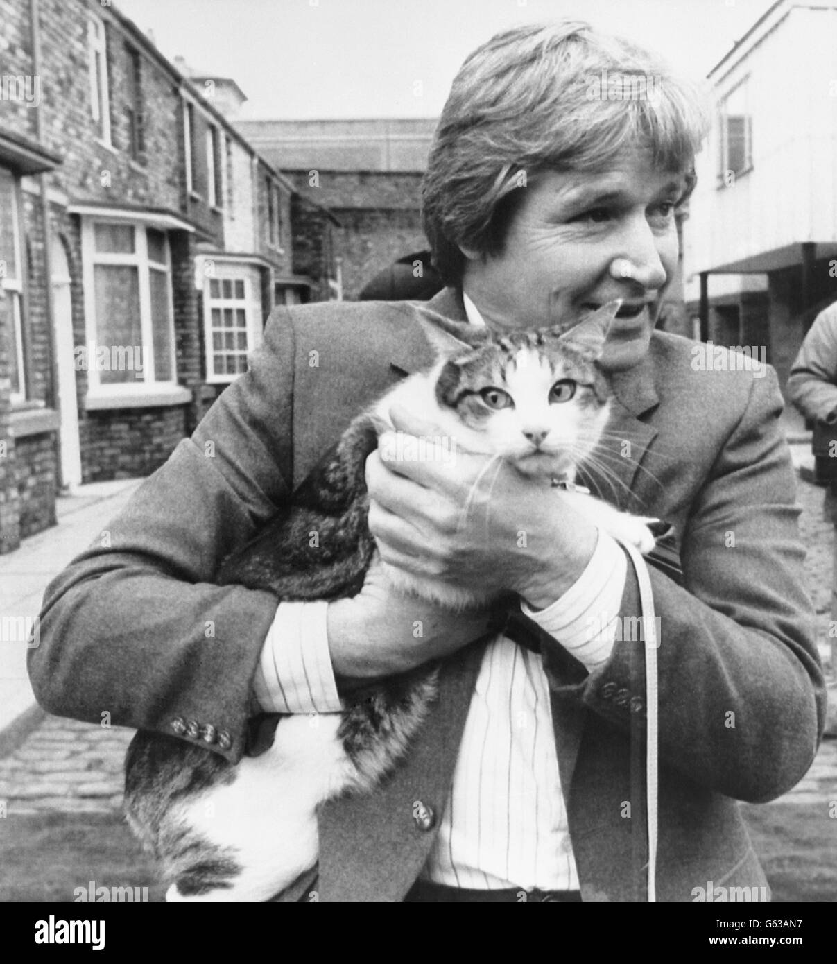 Frisky der Schildkrötenkater, der zum neuen Maskottchen der Coronation Street wurde, wird von dem Schauspieler William Roache, der Ken Barlow spielt, in den Studios von Granada Television in Manchester auf die berühmte Fernsehterrasse eingeführt. Frisky, der in einem umgebauten Schloss in der Nähe von Leeds lebt, wird in den neuen Eröffnungspunkten der SOAP zu sehen sein. Stockfoto