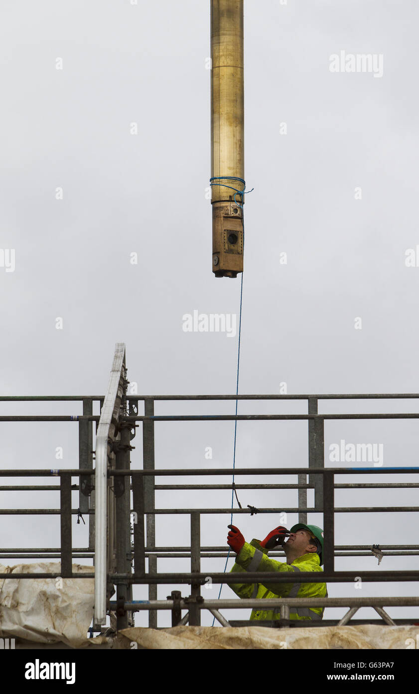 Ingenieure der Babcock International Group stehen bereit, wenn das bronzene Angriffsperiskop sorgfältig an die HMS Alliance im Royal Navy Submarine Museum in Gosport, Hampshire, zurückgegeben wird. Stockfoto