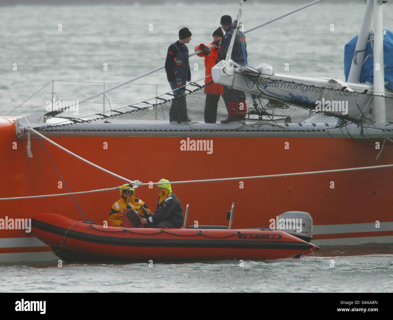 Die Crew von Ellen MacArthur's Kingfisher 2 arbeitet an der Reparatur eines Abschnitts des Masts im Plymouth Sound, Devon, in ihrem Versuch, innerhalb der nächsten 36 Stunden nach der Verzögerung ihres Starts mit dem um die Welt gereisten Geschwindigkeitsrekord zu beginnen. * das Problem mit einer Maststrecke zwang gestern die Absage ihres Rekordangebots zum Start der Jules Verne-Trophäe an der Mündung des Ärmelkanals. Stockfoto