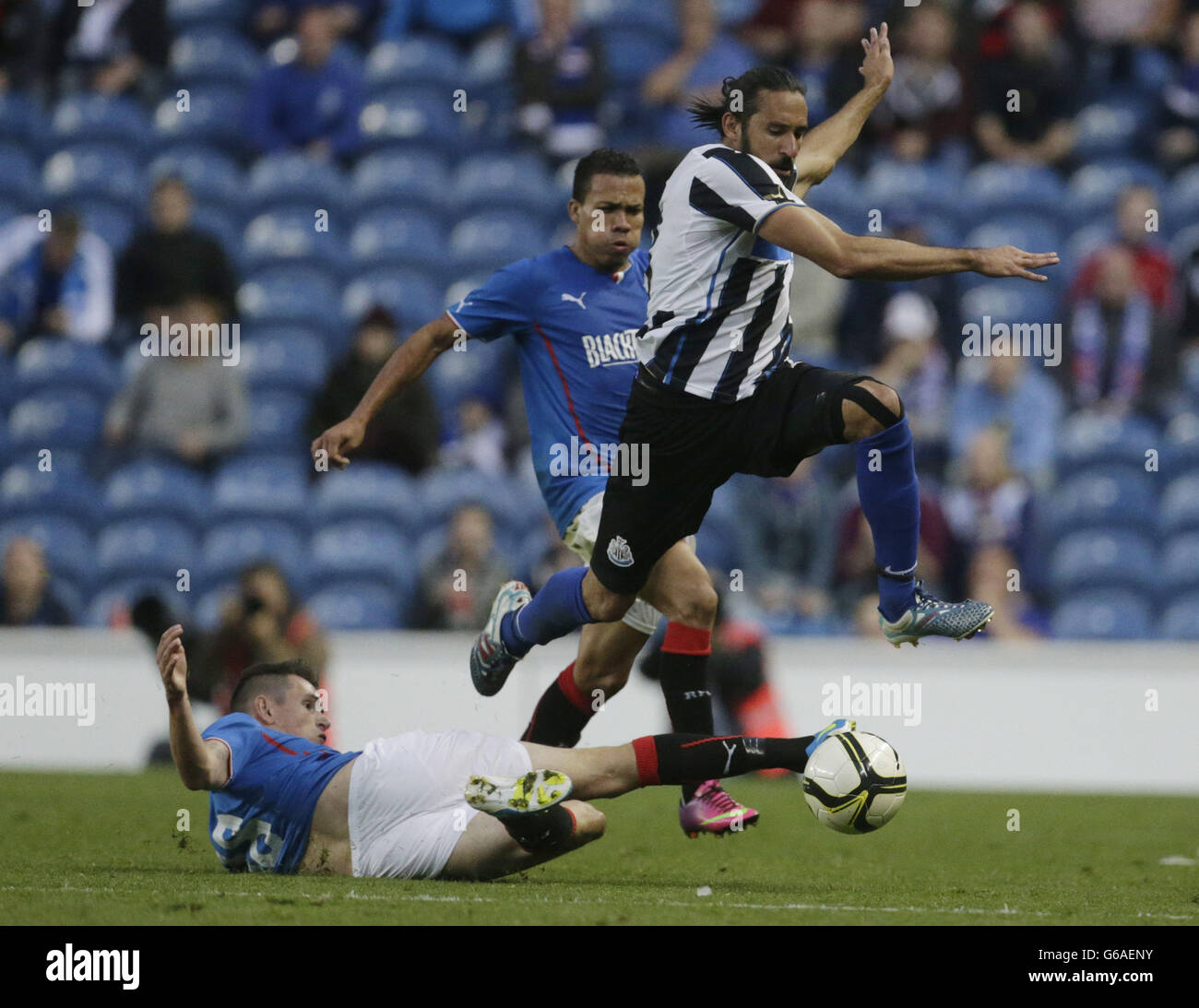 Kyle McAusland von den Rangers und Jonas Gutierrez von Newcastle United kämpfen im Freundschaftsspiel vor der Saison im Ibrox Stadium, Glasgow, um den Ball. Stockfoto