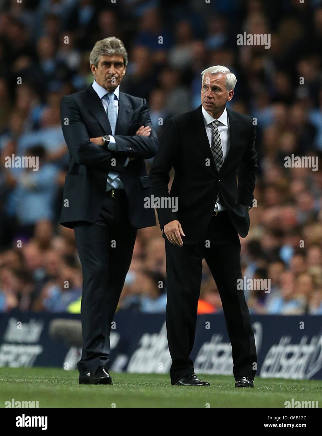 Fußball - Barclays Premier League - Manchester City / Newcastle United - Etihad Stadium. Manuel Pellegrini (links), Manager von Manchester City, und Alan Pardew, Manager von Newcastle United, stehen auf der Touchline. Stockfoto