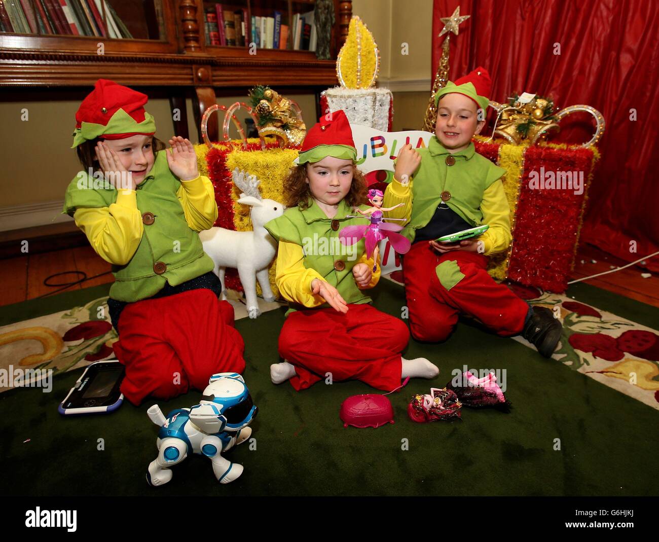 'Santa's Elves' (von links) Abigail Towler, sechs, Aisling O'Sullivan, vier, und Harry Towler, acht, beim Start der offiziellen Dream Toys Liste in Dublin. Stockfoto