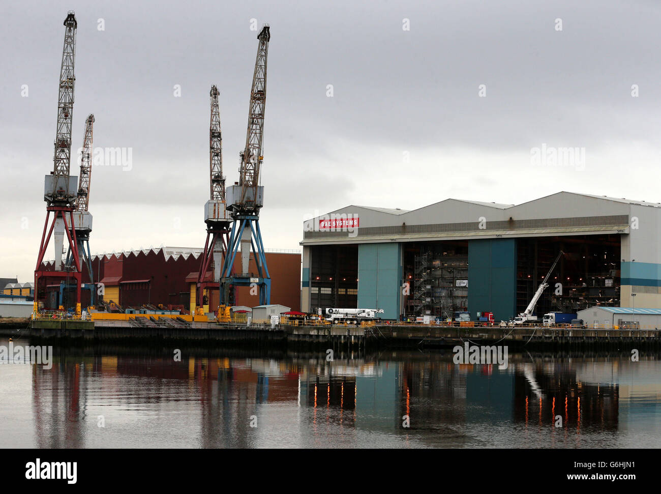 Krane spiegeln sich in der River Clyde bei BAE Systems in Govan, Glasgow, wider, da Hunderte von Schiffsbaustellen in Schottland abgebaut werden, während das Verteidigungsunternehmen sich auf eine umfassende Umstrukturierung seines Schiffsgeschäfts einlässt. Stockfoto