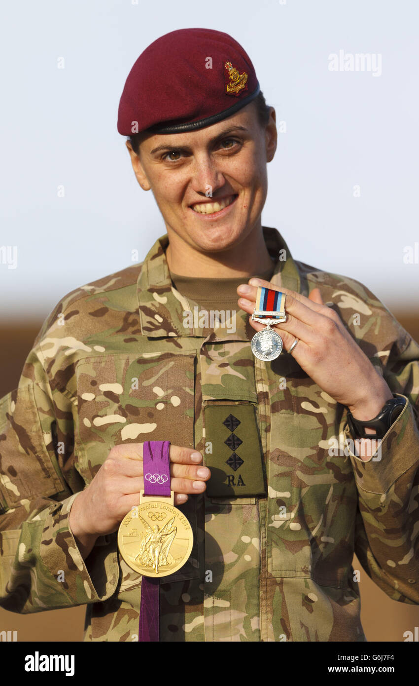 Die olympische Rudergoldmedaillengewinnerin Captain Heather Stanning hält ihre olympische Medaille (links) neben ihrer Operationsmedaille, die ihr nach einer sechsmonatigen Operationstour während der Operation Herrick in Afghanistan nach einer Medaillenparade in Baker Barracks, Thorney Island, Hampshire, überreicht wurde. Stockfoto