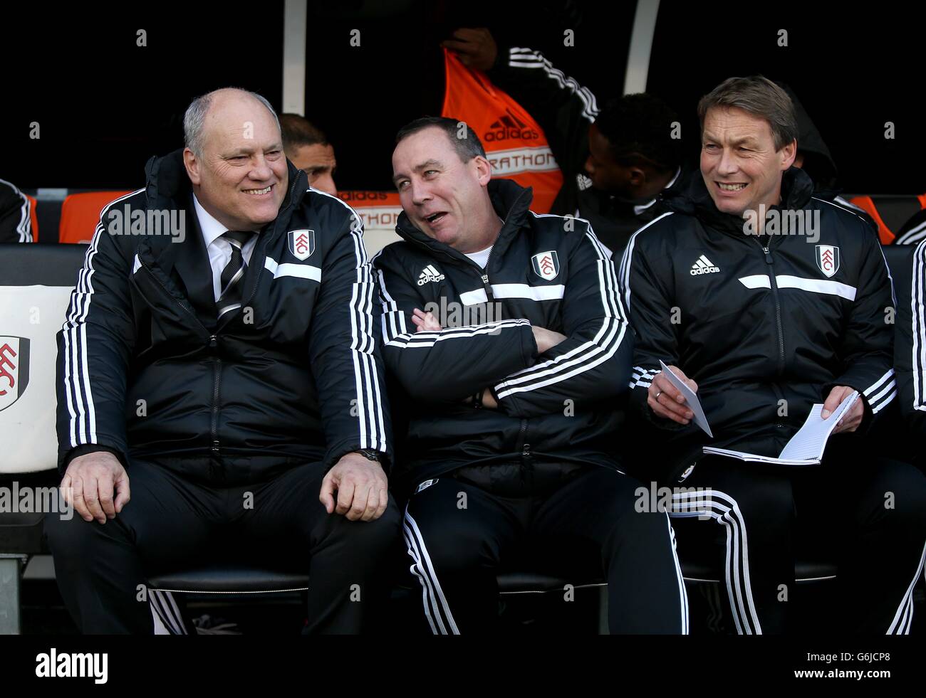 Fußball - Barclays Premier League - Fulham gegen Swansea City - Craven Cottage. Fulham-Manager Martin Jol (links) spricht mit seinem Cheftrainer Rene Meulensteen (Mitte) und Michael Lindeman im Dugout Stockfoto