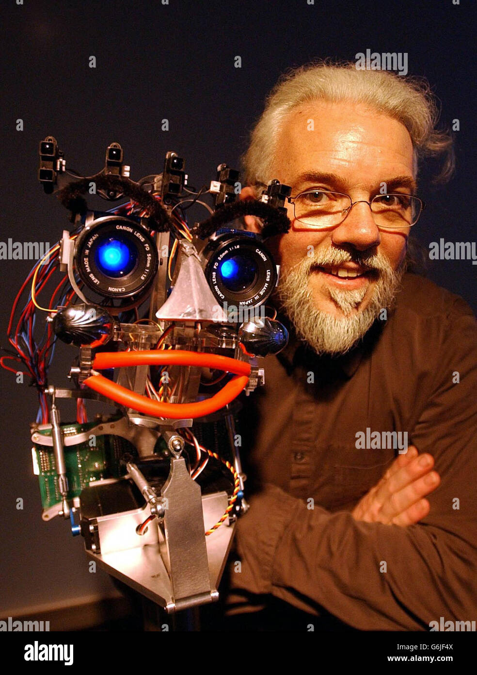 Professor Noel Sharkey von der Sheffield University, ein weltweit führender Robotik-Experte und Richter in TV's "Robot Wars", mit dem Roboter "EMO". Der Roboter, der am 25. Oktober 2003 im "Think Tank" im Science Museum in Birmingham zu sehen ist, wurde von Prof. Sharkey entwickelt, um eine Reihe von Emotionen zu zeigen. Der Roboter ist Teil der Forschung, um Wissenschaftlern zu helfen zu verstehen, wie Menschen Emotionen (die letzte Grenze in der Roboterentwicklung) auf Maschinen zuschreiben. Stockfoto