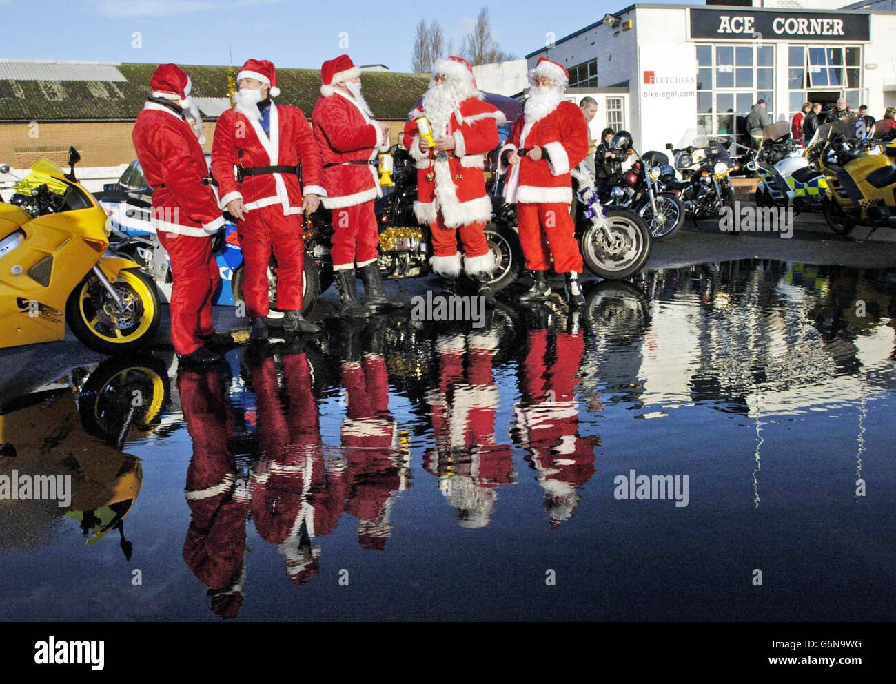 Fünf von über hundert Motorradfahrern, die in Santa Claus-Kostümen gekleidet sind, versammeln sich im Ace Cafe, abseits der North Circular Road, Brent, im Norden Londons, um Kindern Weihnachtsgeschenke im Central Middlesex Hospital, St. Mary's Hospital und St. Thomas' Hospital zu überreichen. Stockfoto