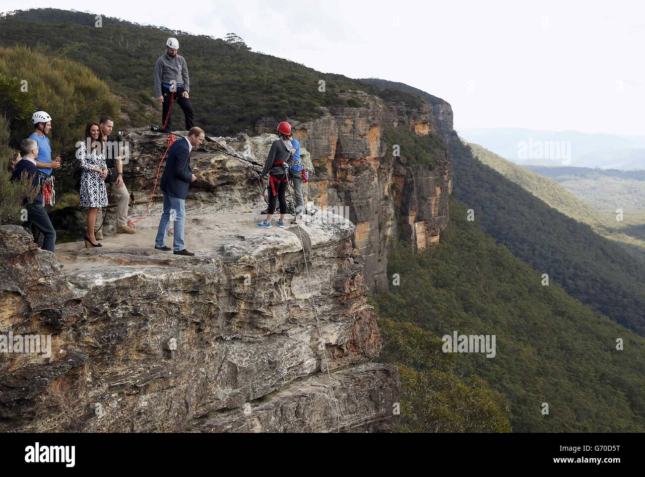 Der Herzog von Cambridge (Mitte) blickt über den Rand einer Klippe, während er und die Herzogin von Cambridge den Narrow Neck Lookout besuchen und beobachtet, wie sich die Mountain Youth Services-Gruppe in der Blue Mountains-Stadt Katoomba, westlich von Sydney, abseilen. Stockfoto