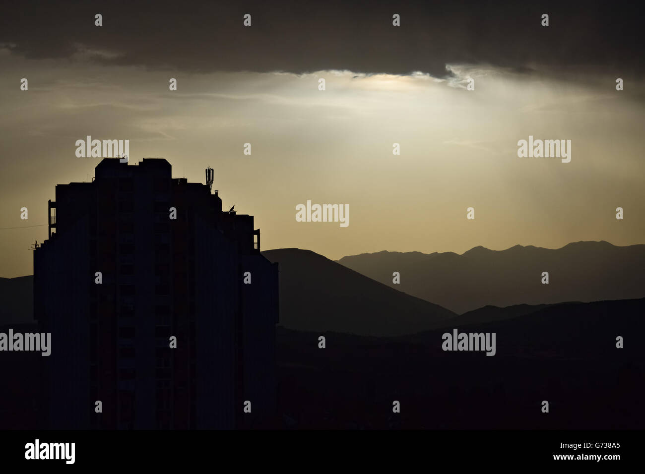 Silhouette von einem Bau- und bewölkten Himmel über der Stadt Stockfoto