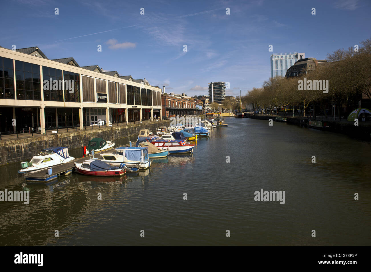 Bristol Harbour mit Blick auf die Anlegestellen und Bars am Wasser und Nachtclubs im Hafen der Stadt Bristol. Es existiert seit dem 13. Jahrhundert, wurde aber zu Beginn des 19. Jahrhunderts zu seiner heutigen Form weiterentwickelt, indem es Schleusentore auf einem Gezeitenabschnitt des Flusses Avon im Zentrum der Stadt installierte und einen Gezeitenumlauf für den Fluss zur Verfügung stellte. Er wird als schwimmender Hafen bezeichnet, da der Wasserstand konstant bleibt und er nicht vom Gezeitenzustand auf dem Fluss beeinflusst wird Stockfoto