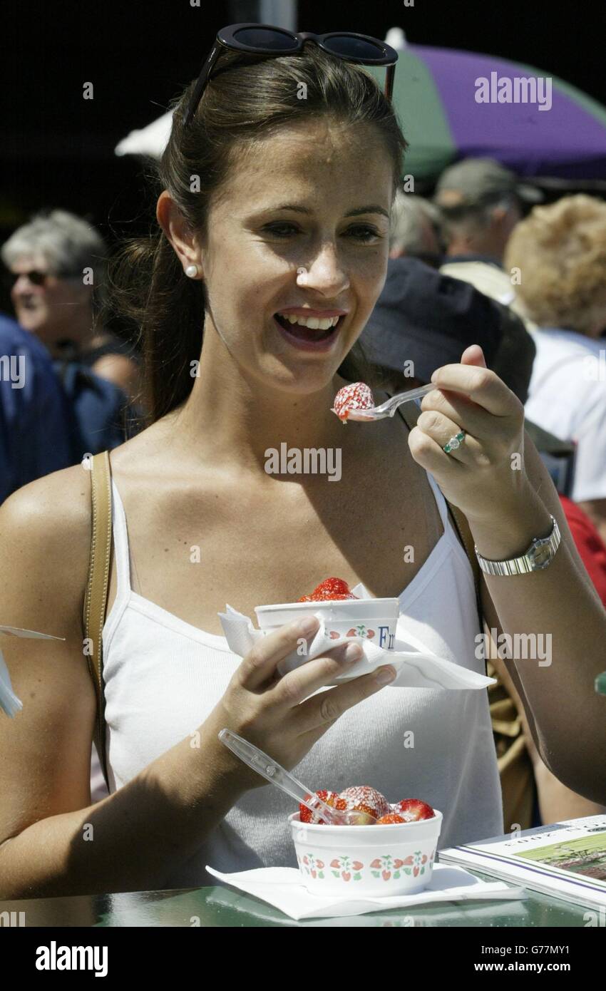 Simona Invernizzi aus Middlesex genießt die berühmten Erdbeeren und Cremes der All England Lawn Tennis Championship in Wimbledon. Stockfoto
