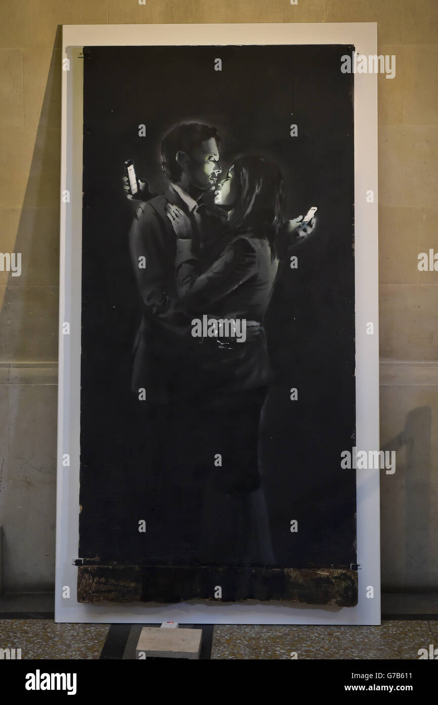 Banksy Kunstwerk 'Mobile Lovers' im Bristol Museum & Art Gallery, wo es angekündigt wird, dass das Kunstwerk verkauft wurde. Stockfoto