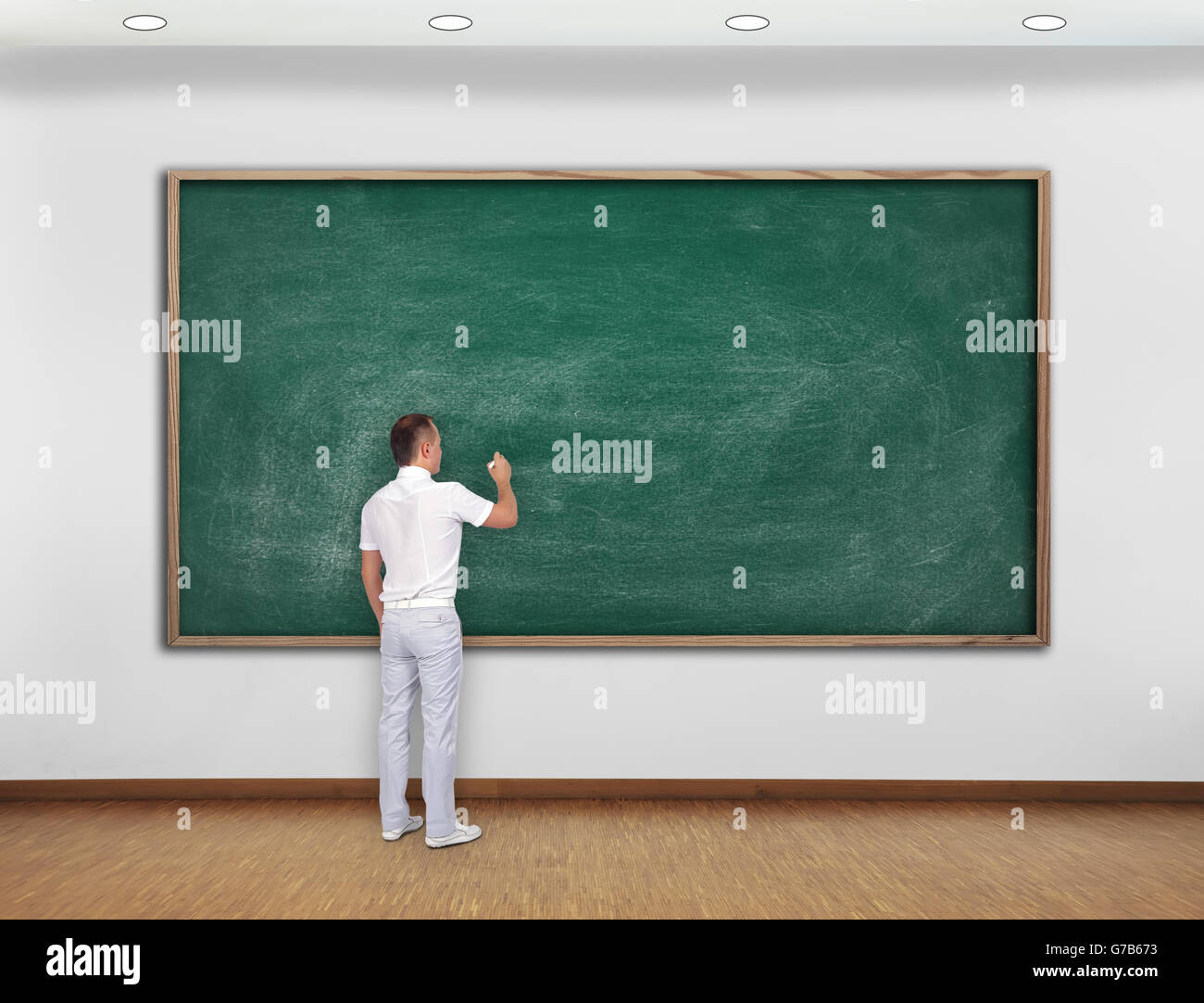Lehrer auf leere grüne Tafel im Raum Stockfoto