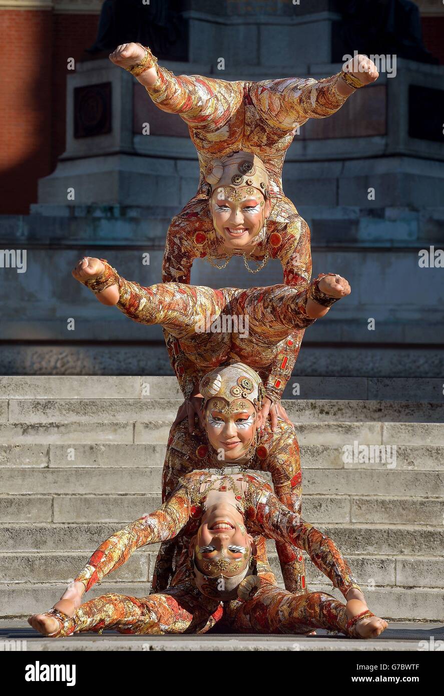 Ein Trio mongolischer Contortionisten aus der Cirque du Soleil-Show Kooza zeigt ihre besonderen Fähigkeiten vor der Royal Albert Hall, wo die Produktion ab dem 6. Januar 2015 für ihre jährliche limitierte Serie an den Londoner Veranstaltungsort zurückkehren wird. Stockfoto