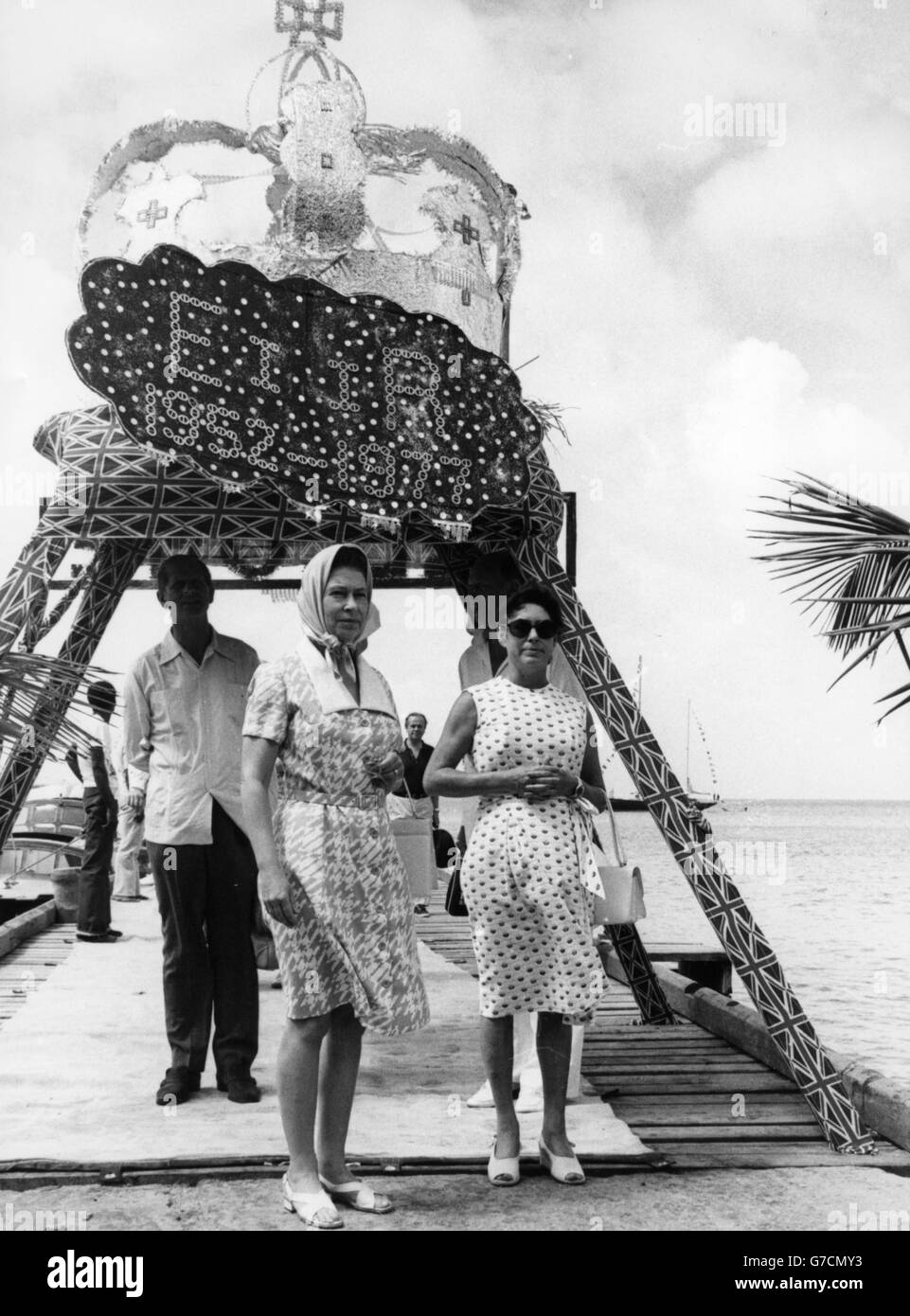Ein spezielles Baldachin mit Union Flaggen und einer riesigen silbernen Krone begrüßt Königin Elizabeth II und Prinz Philip, als sie auf der karibischen Insel Mustique zur letzten Etappe ihrer Silver Jubilee Tour ankommen. Sie wurden von Prinzessin Margaret begrüßt, die ein Ferienhaus auf der Insel hat. Stockfoto