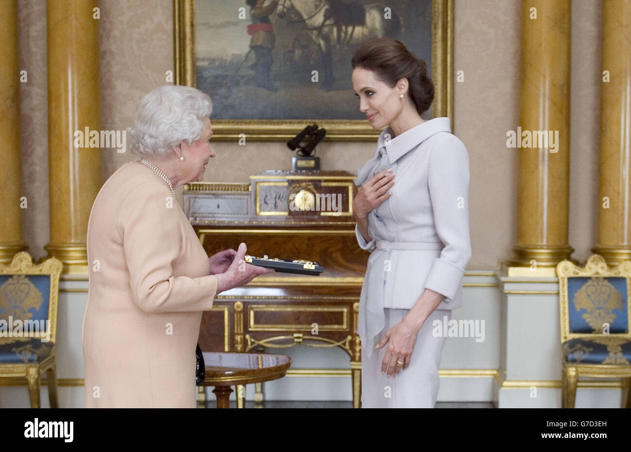 Die Schauspielerin Angelina Jolie wird von Königin Elizabeth II. Im Saal 1844 im Buckingham Palace, London, mit dem Insignia einer Ehrendame Commander des Most Distinguished Order of St Michael and St George überreicht. Stockfoto