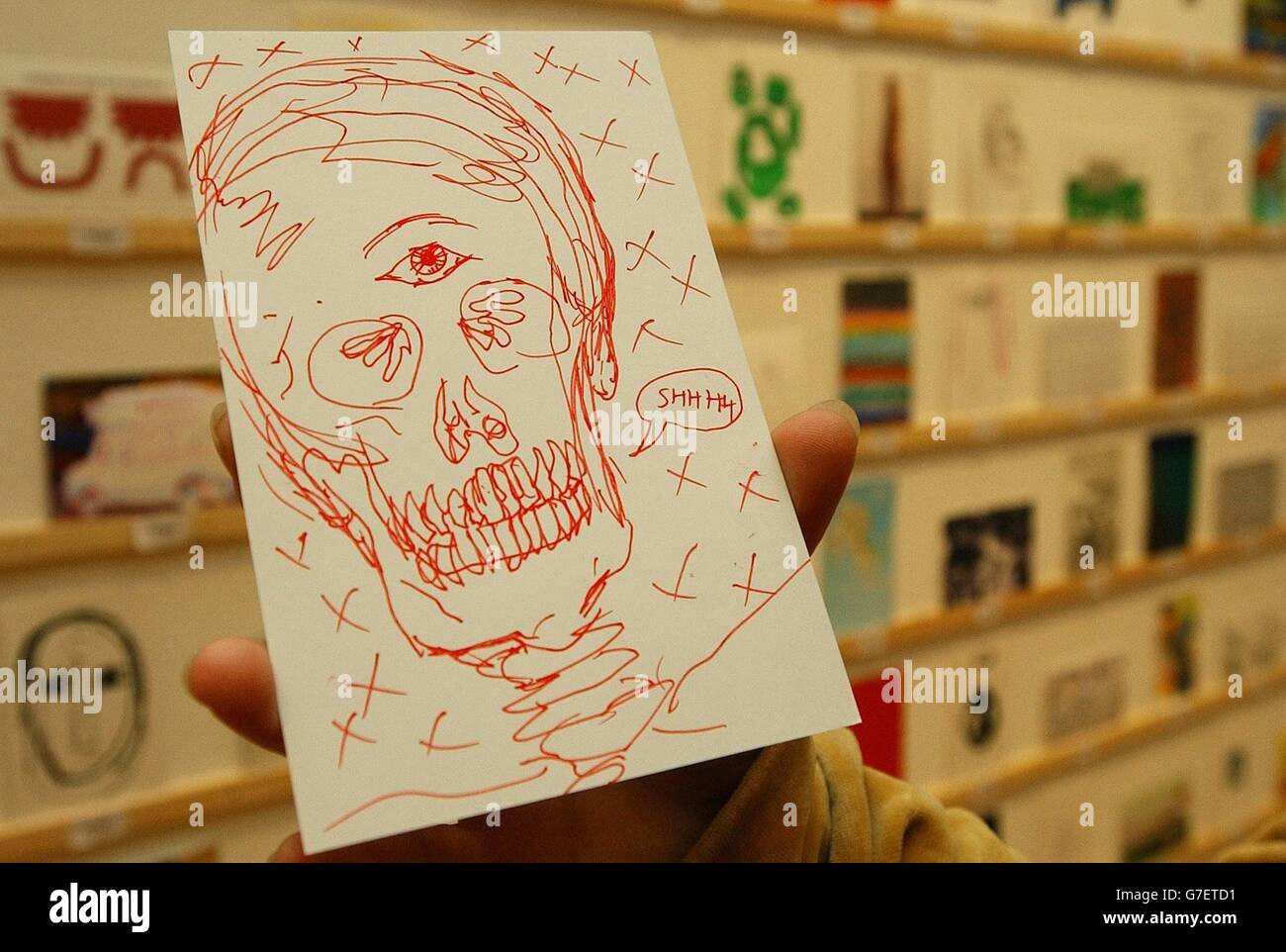 Eine Postkarte des Künstlers Damien Hirst wird von Elisabeth Lecourt, 31 aus Bermondsey, am Royal College of Art in Kensington, West London, gehalten. Nach fünf Nächten Schlange hatte Frau Lecourt das Glück, die Postkarte des Künstlers im anonymen RCA Secret-Verkauf auszuwählen. Mehr als zweitausend Postkarten von Künstlern wie David Hockney, Tracey Emin, Sir Peter Blake und Mario Testino sind zusammen mit der Arbeit der Studenten an der Hochschule bei 35 erhältlich. Stockfoto