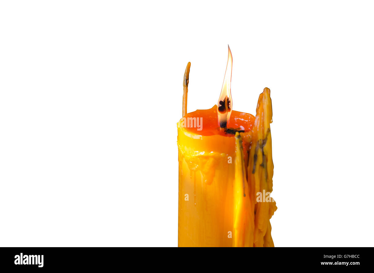 Eine helle Kerze brennt hell in den weißen Hintergrund. Stockfoto