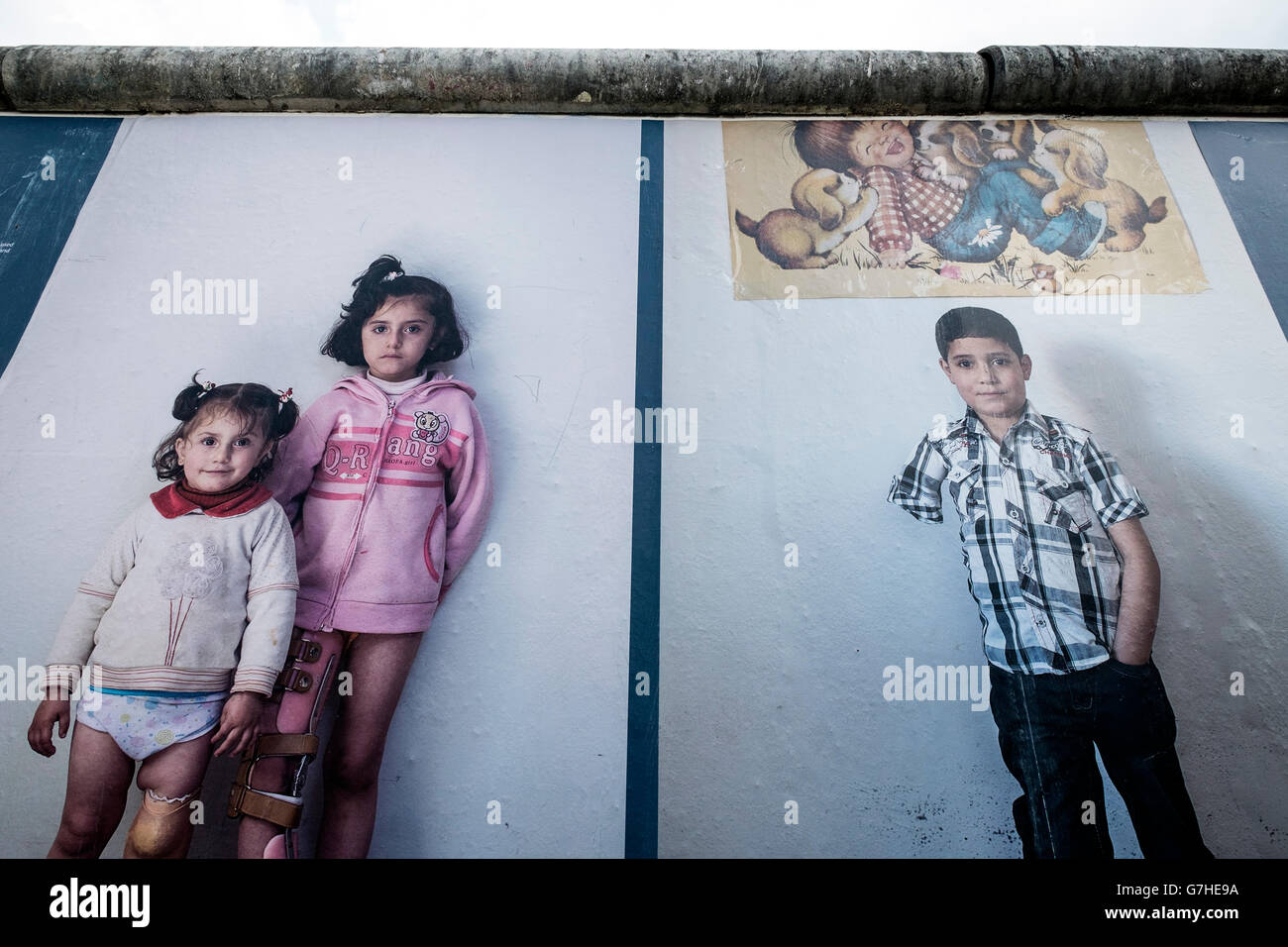 Bilder aus dem Krieg an Wand, eine Fotoausstellung über den Krieg in Syrien von Kai Wiedenhofer im Freien auf der Berliner Mauer angezeigt Stockfoto