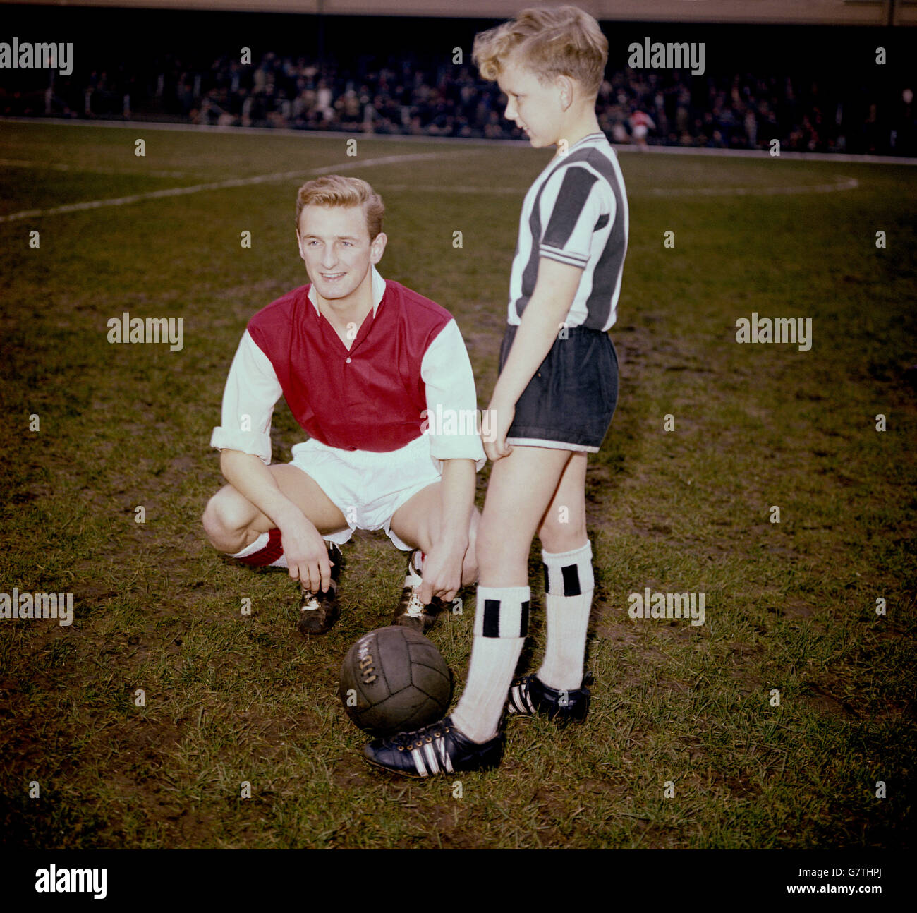 Arsenals George Eastham (l) posiert mit dem Maskottchen Newcastle United vor dem Spiel, weniger als drei Monate nach Abschluss seines langwierigen und umstrittenen Transfers von Newcastle nach Arsenal. Eastham stellte das damals im englischen Fußball geltende Rückbehalt- und Transfersystem in Frage und gewann einen Fall vor dem Obersten Gerichtshof, in dem das Recht eines Spielers auf eine Übertragung festgelegt und das Rückbehalt- und Transfersystem als unangemessene Handelsbeschränkung erklärt wurde. Stockfoto