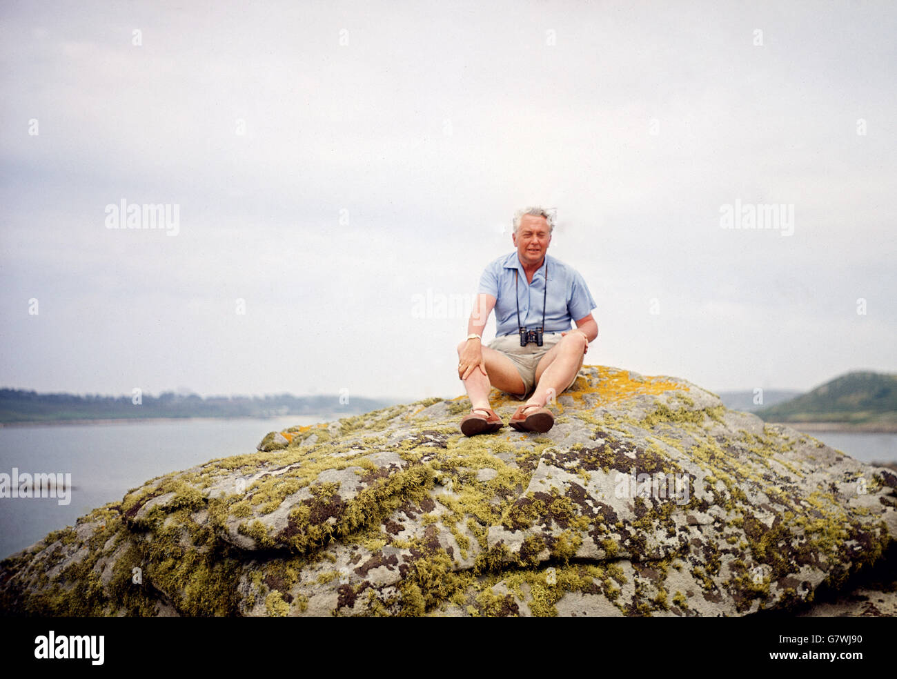 Premierminister Harold Wilson sitzt während seiner Sommerferien auf den Scilly-Inseln auf einem Felsen. Stockfoto
