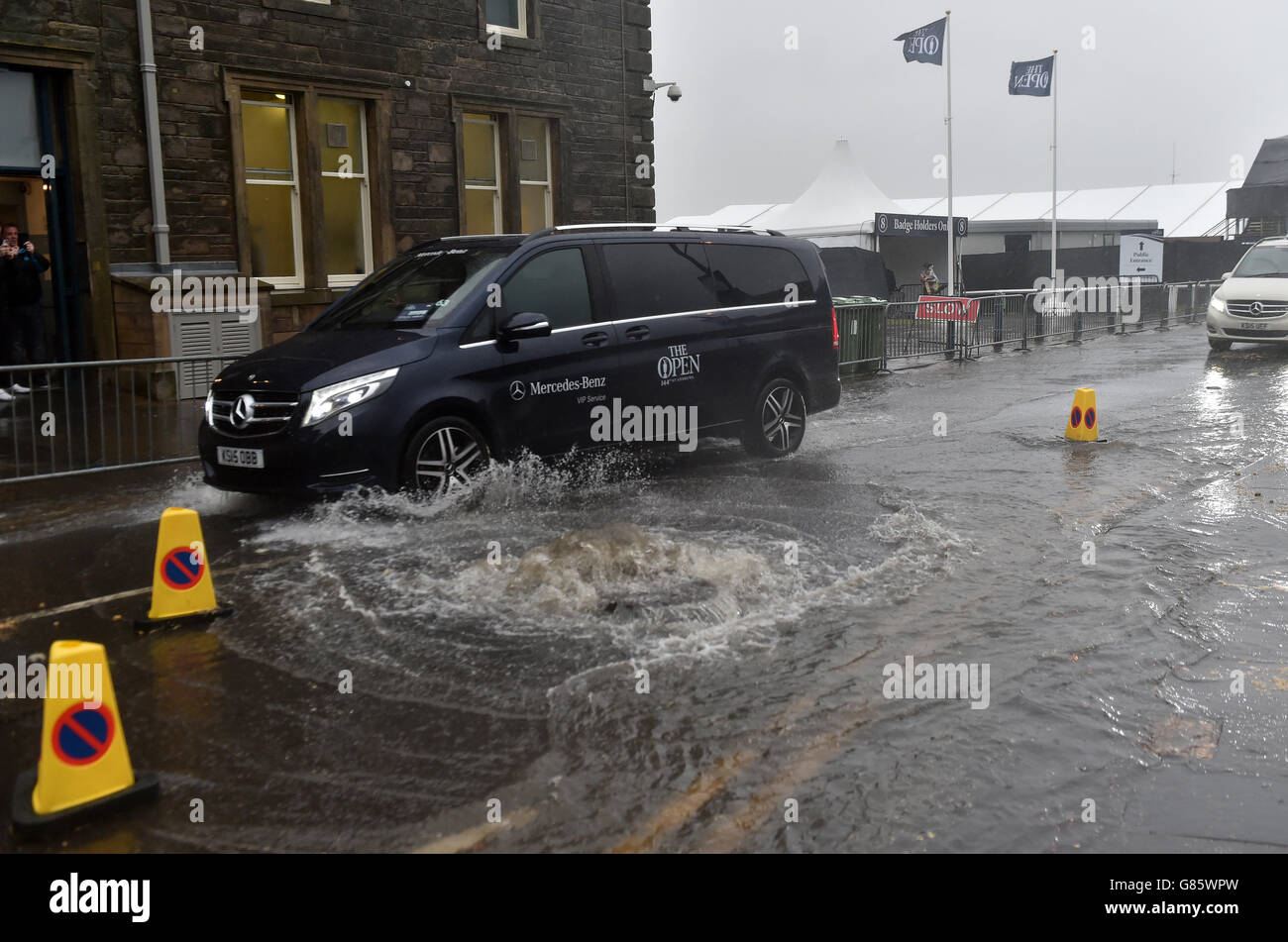 Ein Auto der Marke „The Open“ fährt durch eine überflutete Straße außerhalb von St Andrews, Fife. Stockfoto