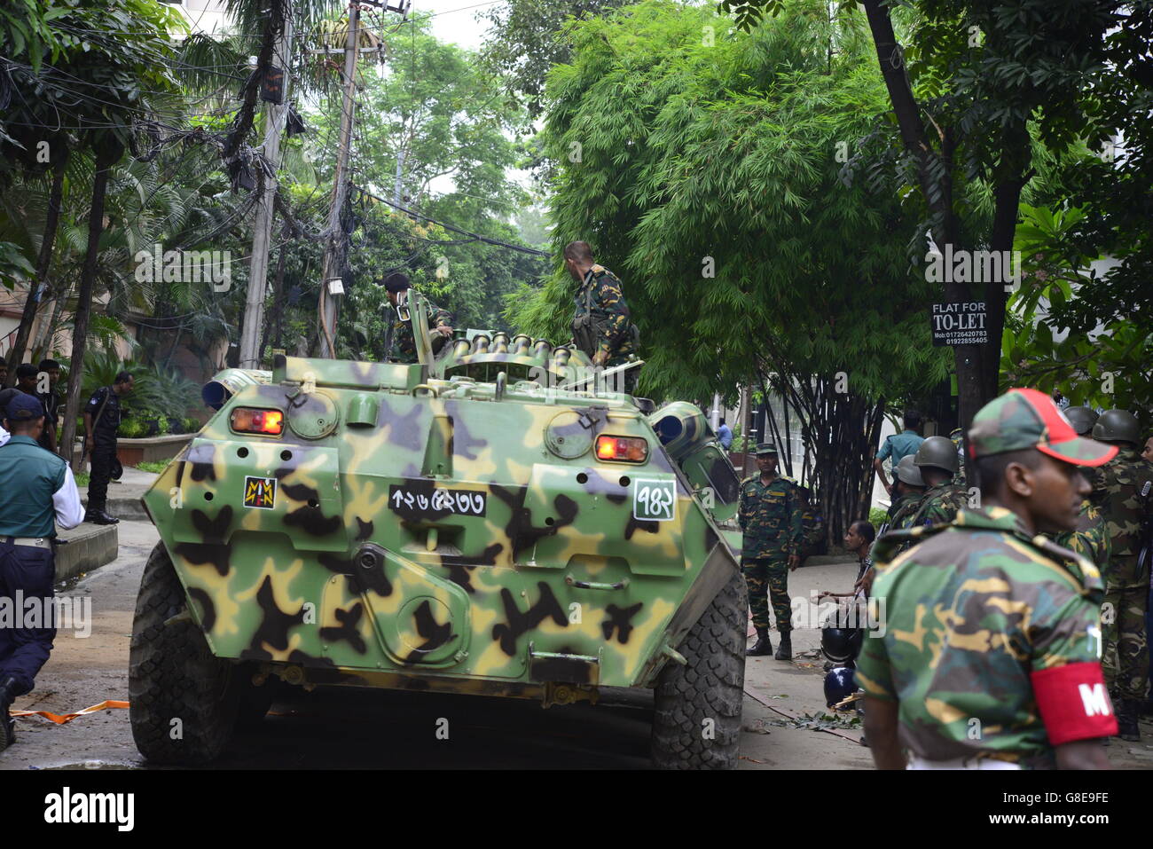 Militär Panzer aus Bangladesch macht seinen Weg vorbei an Journalisten, Zuschauer und Polizei in der Nähe ein gehobenes Restaurant in Dhaka am 2. Juli 2016, nach einem blutigen Belagerung durch bewaffnete Angreifer, die am 1. Juli begonnen. Schwer bewaffnete Kämpfer ermordeten 20 Geiseln in Bangladesch, viele ihrer Opfer zu Tode, hacking, bevor sechs der Angreifer am Ende einer Belagerung niedergeschossen wurden 2 Juli in einem Restaurant mit Ausländern verpackt. Wie die Gruppe islamischer Staat (IS) Verantwortung für das Blutbad zu Beginn des Urlaubs Eid behauptet, sagte Premierminister Sheikh Hasina, dass sie fest entschlossen war, Militanz zu beseitigen Stockfoto