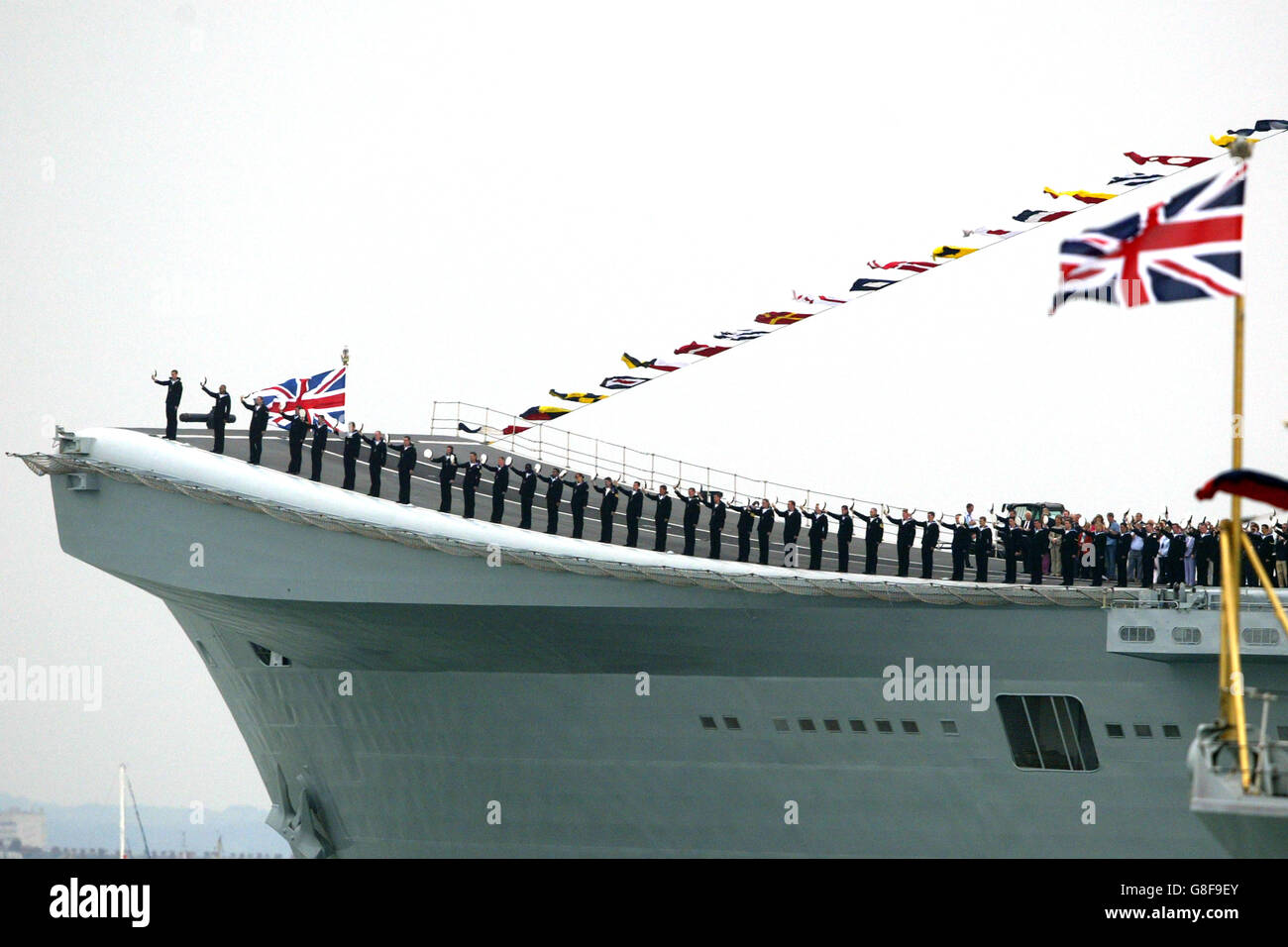 Die Besatzung von HMS Invincible grüßt als HMS Endurance mit der britischen Königin Elizabeth II. Während der International Fleet Review in Spithead, vor Portsmouth, vorbeikommt. Stockfoto