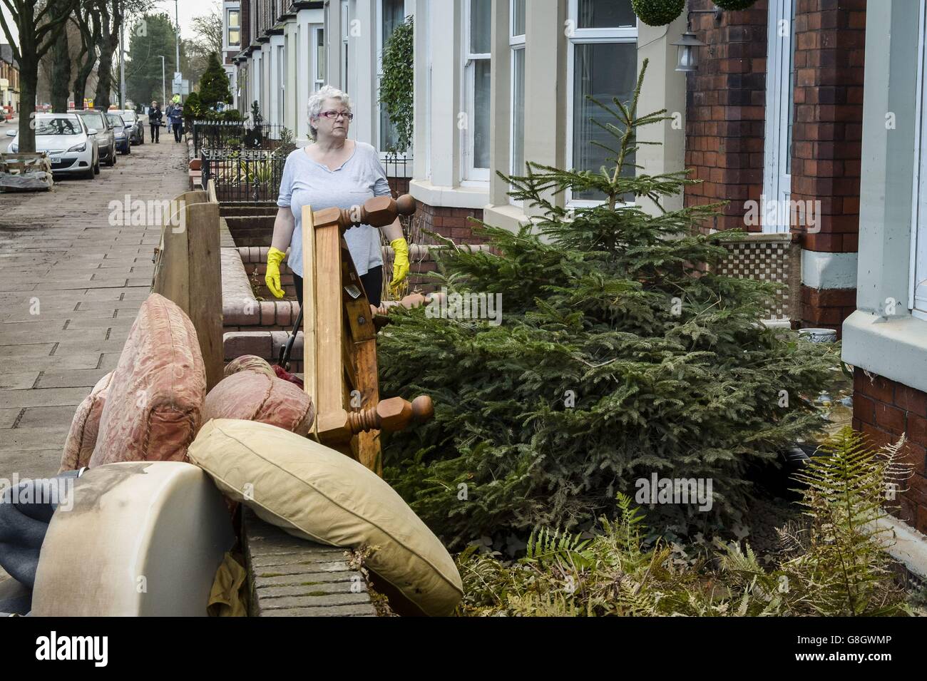 Nach den Überschwemmungen in Carlisle beginnen die Säuberungen an der Warwick Road, und die Menschen räumen ihre Häuser von wassergeschädigtem Eigentum, darunter einen Weihnachtsbaum. Stockfoto