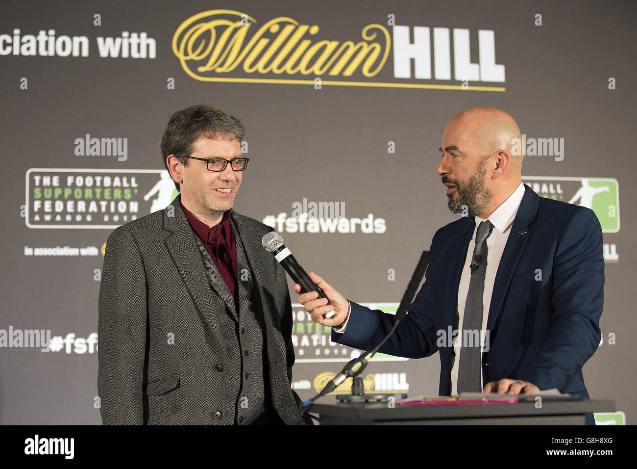 Ian King von TwoHundredPercent (links) wird von Moderator James Richardson interviewt, nachdem er seinen Preis für den besten Blog während der Football Supporters Federation Awards 2015 in Zusammenarbeit mit William Hill im St Pancras Renaissance Hotel, London, erhalten hat. Stockfoto