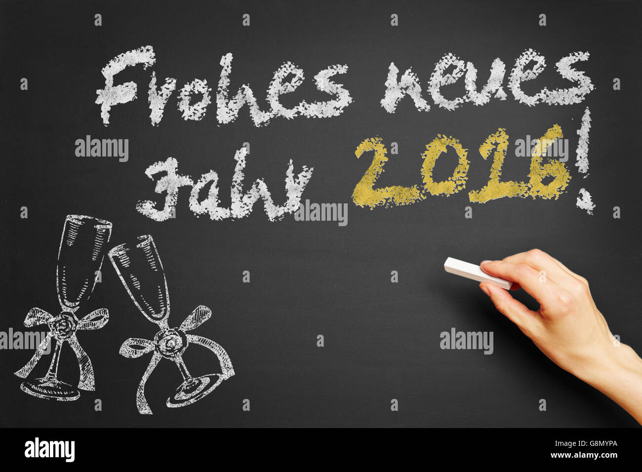 Hand, schreibt in Deutsch "Frohes Neues Jahr 2016!" (Frohes neues Jahr 2016!) auf Tafel Stockfoto