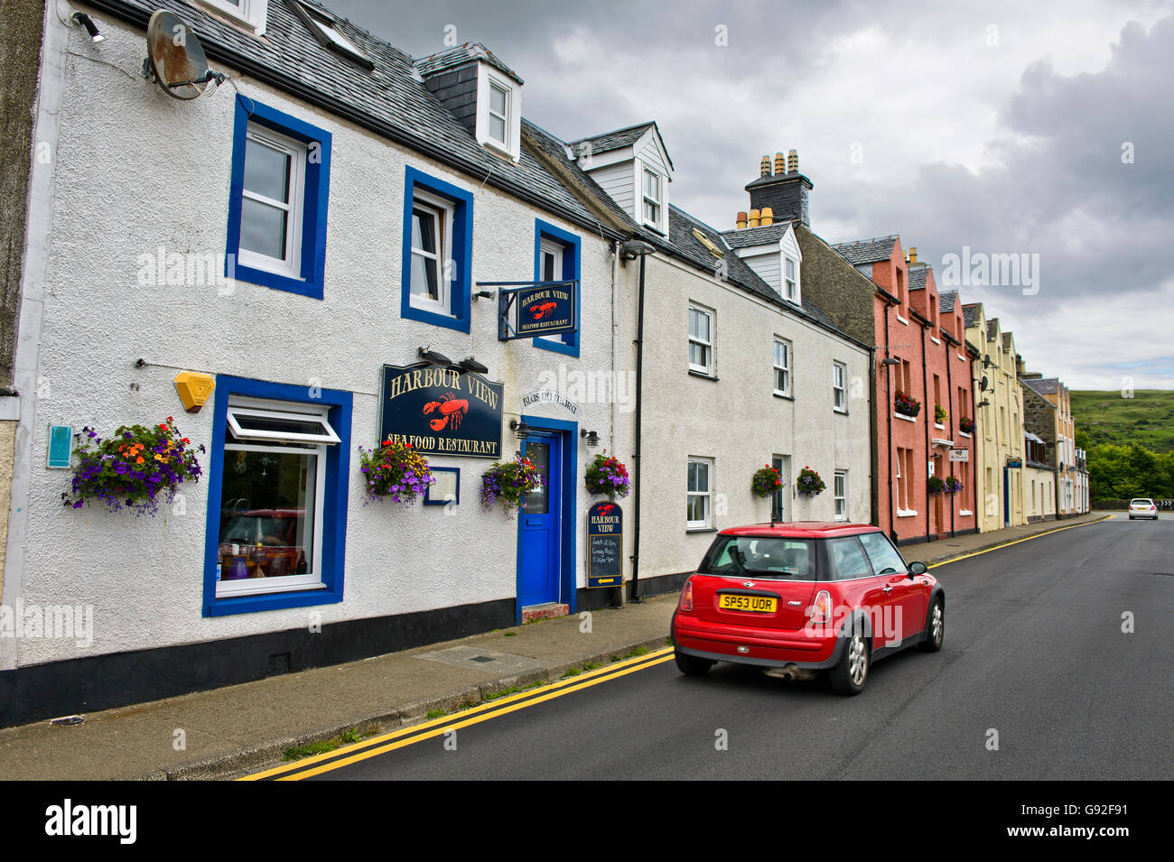 Rote Mini Auto vorbei an der Harbour View Seafood Restaurant, Portree, Isle Of Skye, Schottland, Großbritannien Stockfoto